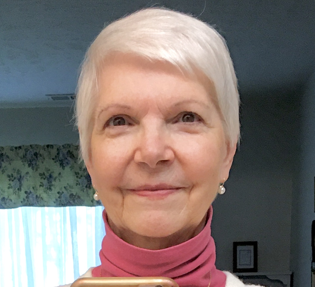 Kingdom Gowns artisan hand-stitching lace onto a silk christening gown using French couture technique — Kentwood, Michigan