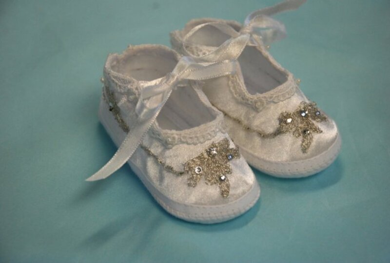 Pair of handmade white christening baby shoes with gold cross embellishment and crystal accents — Kingdom Gowns Michigan