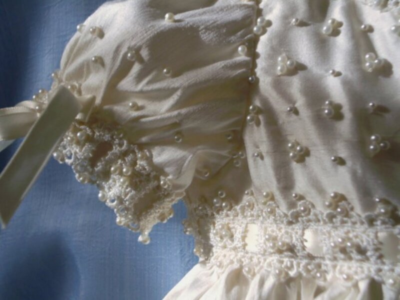 Pearl-embellished ivory christening bonnet with scalloped lace trim and hand-stitched pearl accents — Kingdom Gowns Michigan