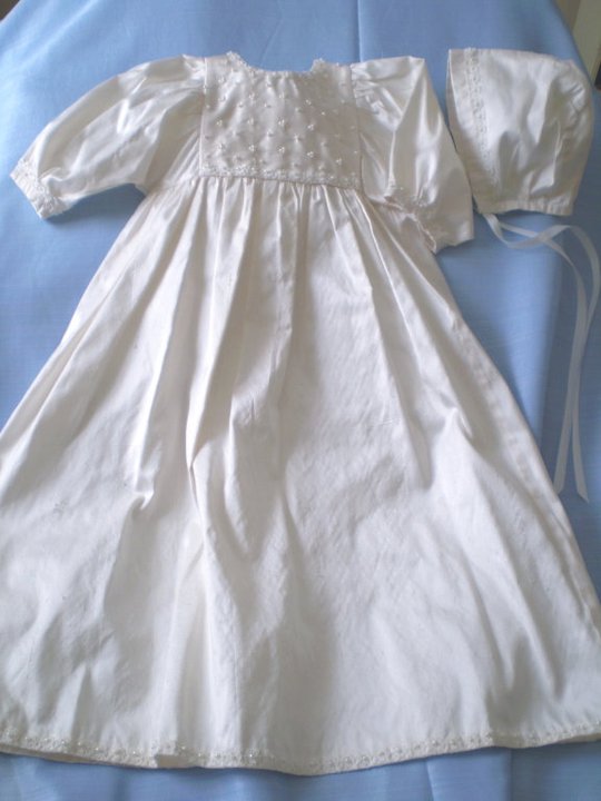 White satin christening gown with embroidered pearl bodice displayed with matching bonnet — Kingdom Gowns Michigan